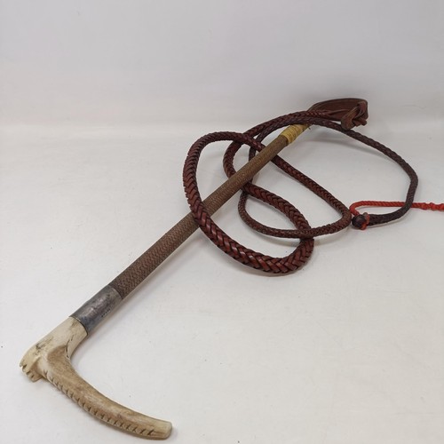 725 - A horn handled crop, with a silver mount and a whip (2)