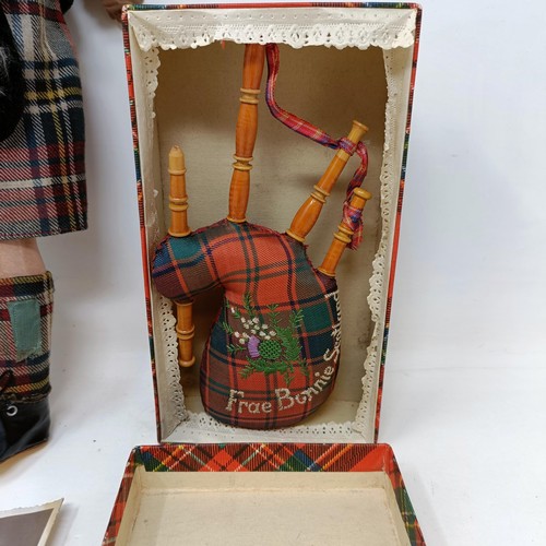 210 - An Armand Marseille bisque headed doll, No. 390, in a Scottish costume with bagpipe