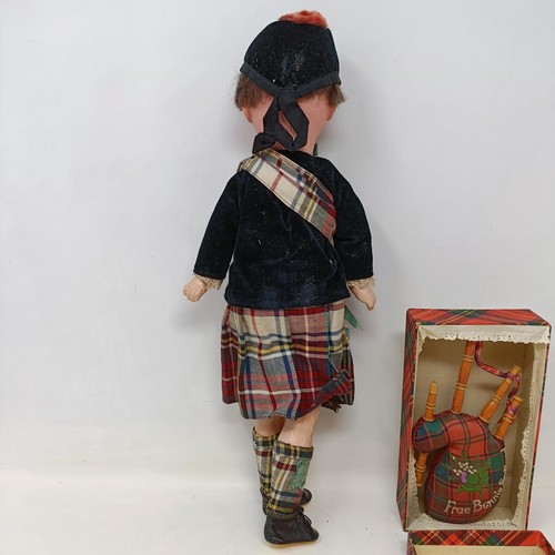 210 - An Armand Marseille bisque headed doll, No. 390, in a Scottish costume with bagpipe