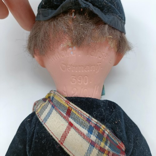 210 - An Armand Marseille bisque headed doll, No. 390, in a Scottish costume with bagpipe