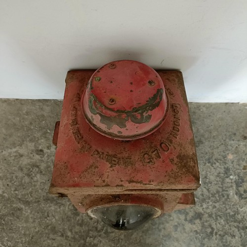 735 - A red painted cast metal railway stop lantern, and four other lanterns (5)