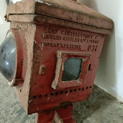 735 - A red painted cast metal railway stop lantern, and four other lanterns (5)