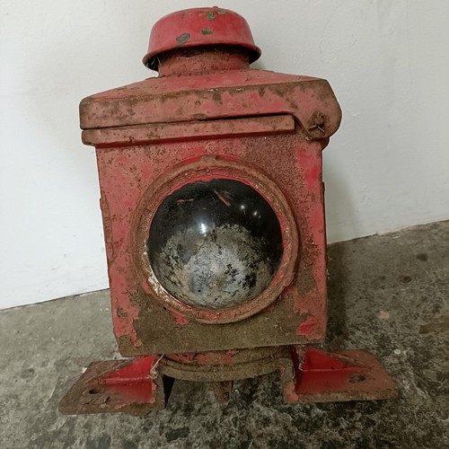 735 - A red painted cast metal railway stop lantern, and four other lanterns (5)