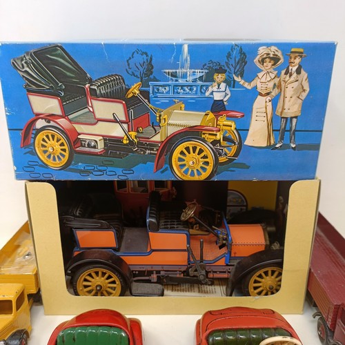 223 - A Schuco Tacho-Examico 4002 toy car, Schuco Akustico 2202, a reproduction Schuco Oldtimer boxed, and... 