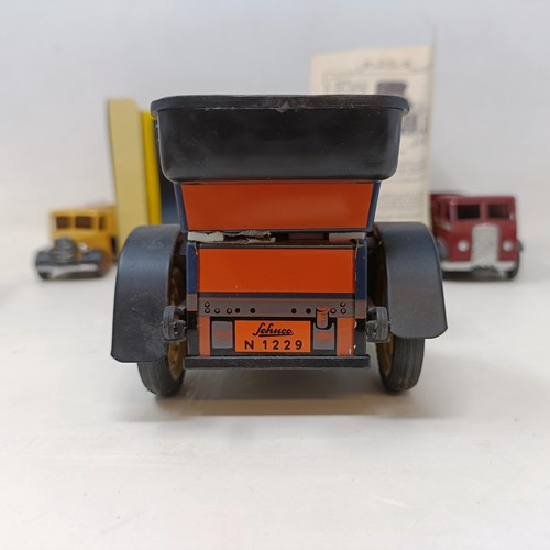 223 - A Schuco Tacho-Examico 4002 toy car, Schuco Akustico 2202, a reproduction Schuco Oldtimer boxed, and... 