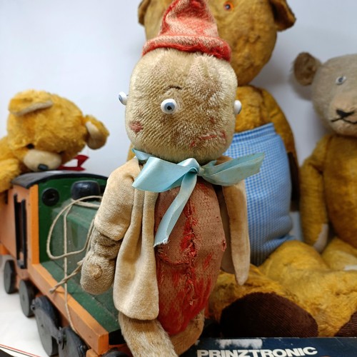 243 - A well loved teddy bear, three others, and a painted pull-along locomotive (box)