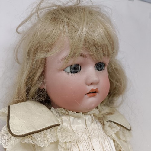 254 - A Simon & Halbig bisque headed doll, with millefiori eyes and a hinged composite body, 75 cm