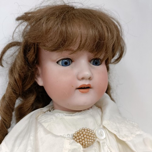 256 - An Armand Marseille bisque headed doll, with closing millefiori glass eyes and a jointed composite b... 