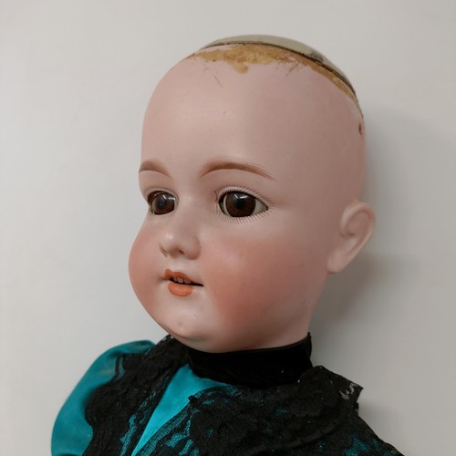 257 - An Armand Marseille bisque headed doll, with closing millefiori eyes and a hinged composite body, la... 