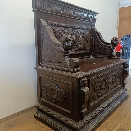 872 - A late Victorian carved oak box settle, 110 cm wide