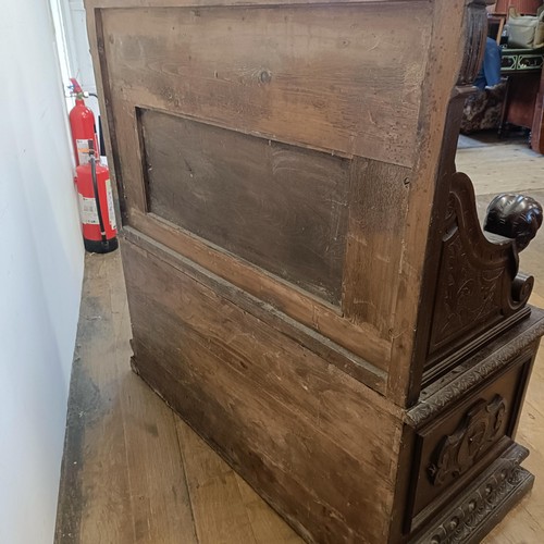 872 - A late Victorian carved oak box settle, 110 cm wide