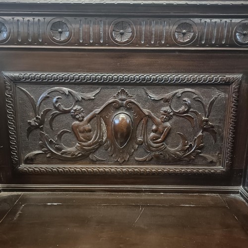 872 - A late Victorian carved oak box settle, 110 cm wide