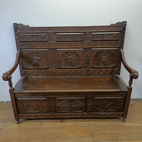 883 - A carved oak box settle, John Whatton Katherine/Gods Providence Is Mine Inheritance, 150 cm wide