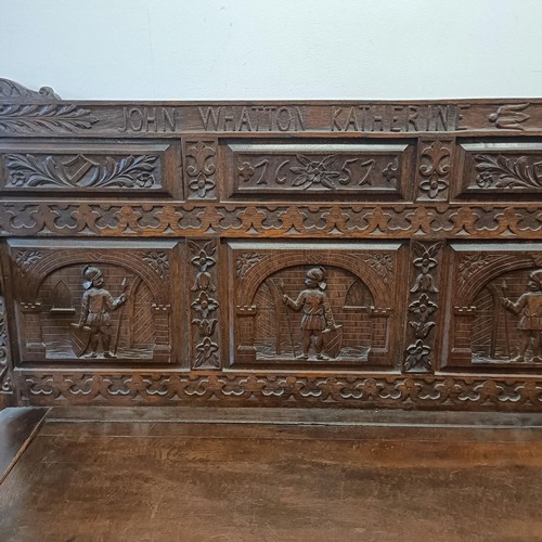 883 - A carved oak box settle, John Whatton Katherine/Gods Providence Is Mine Inheritance, 150 cm wide