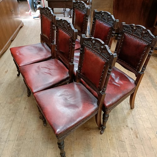 901 - A set of six late 19th century carved walnut dining chairs, with leather padded backs and seats (6)