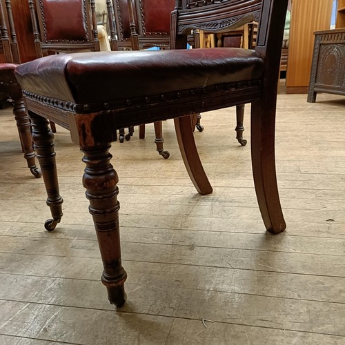 901 - A set of six late 19th century carved walnut dining chairs, with leather padded backs and seats (6)