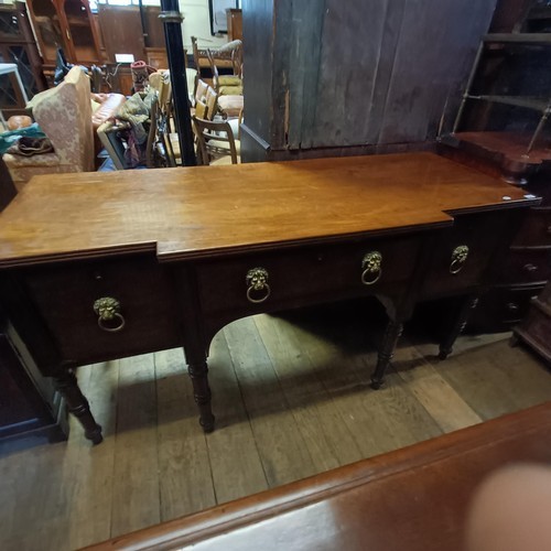 910 - An early 19th century breakfront mahogany sideboard, on tapering turned legs, 183 cm wide