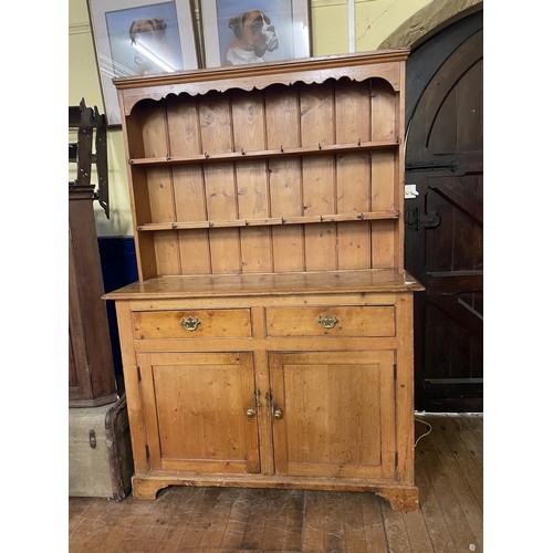 975 - A stripped pine kitchen dresser, 137 cm wide