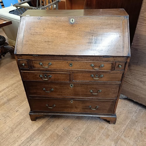 988 - A George III oak bureau, 93 cm wide, an oak cupboard, 95 cm wide, a folding card table and a washsta... 