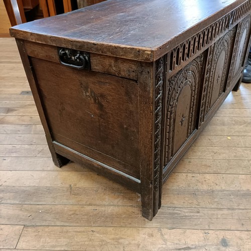 998 - An 18th century carved oak coffer, 117 cm wide