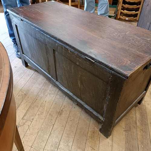 998 - An 18th century carved oak coffer, 117 cm wide