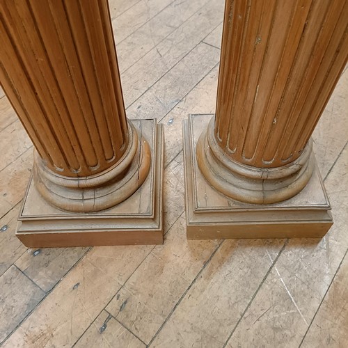 999 - A pair of pine pedestals in the form of Corinthian columns, 114 cm high