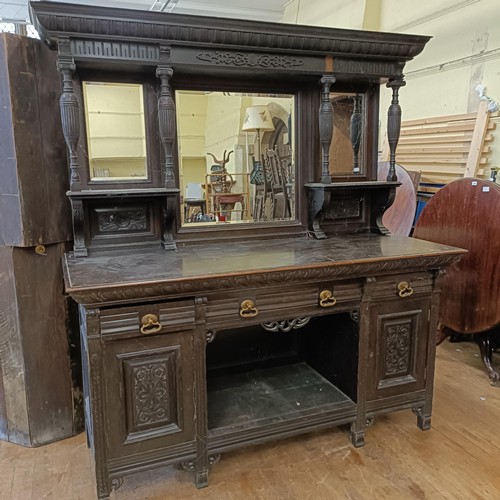 1001 - A large oak dresser, with a mirrored back on a base with three drawers and two cupboard doors, 186 c... 