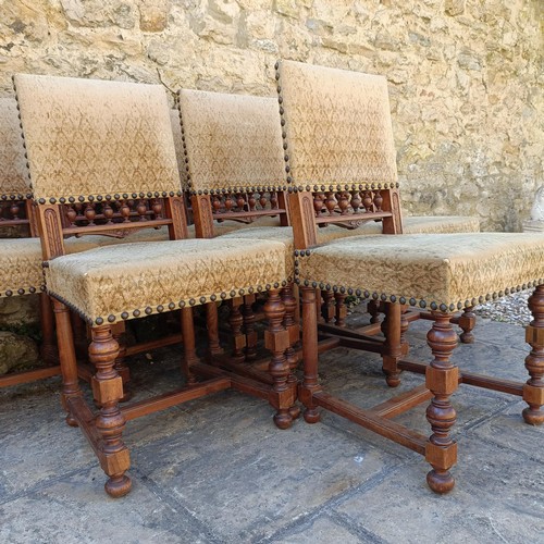 1010 - A set of eight walnut framed dining chairs, with padded back and seat (8)