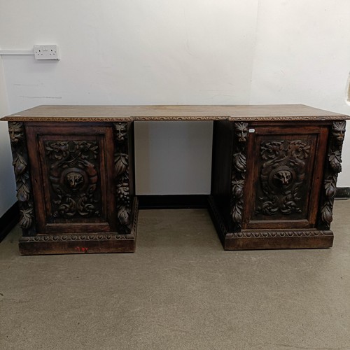 1034 - A carved oak sideboard, 187 cm wide