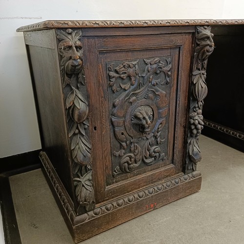 1034 - A carved oak sideboard, 187 cm wide