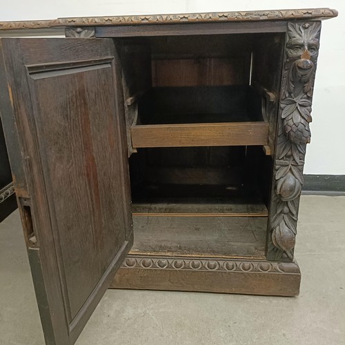 1034 - A carved oak sideboard, 187 cm wide