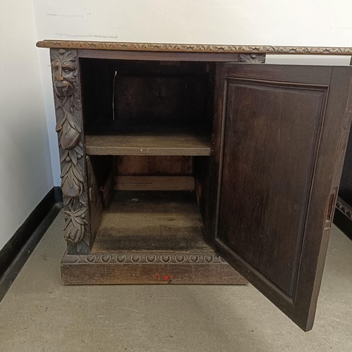 1034 - A carved oak sideboard, 187 cm wide