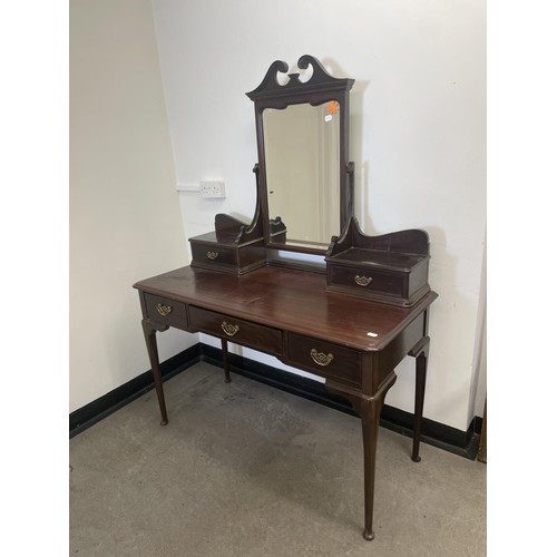 973 - A Gillows mahogany dressing table, the central drawer stamped, 128 cm wide