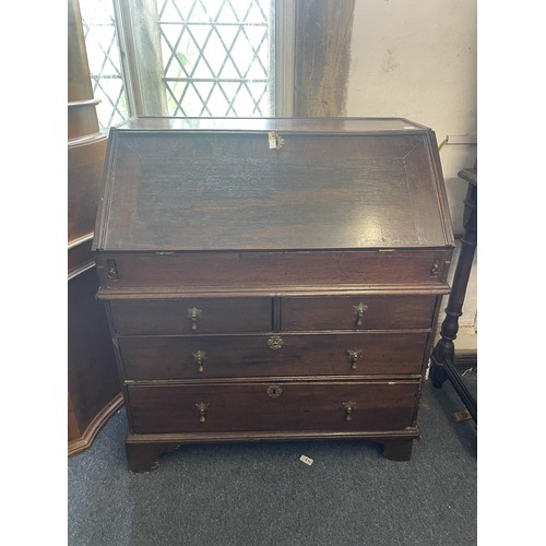 962 - An 18th century oak bureau, the fall front to reveal drawers, a well and pigeon holes, with alterati... 