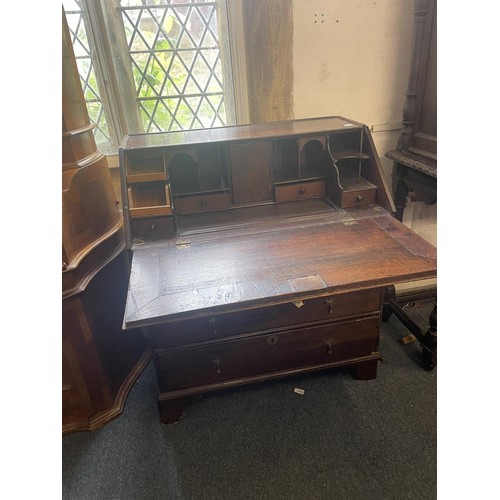 962 - An 18th century oak bureau, the fall front to reveal drawers, a well and pigeon holes, with alterati... 