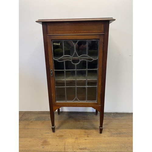 965 - An Edwardian mahogany music cabinet, with a leaded glazed door, 60 cm wide