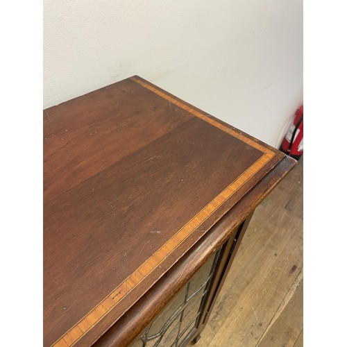 965 - An Edwardian mahogany music cabinet, with a leaded glazed door, 60 cm wide