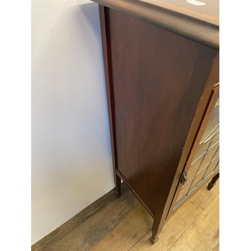 965 - An Edwardian mahogany music cabinet, with a leaded glazed door, 60 cm wide