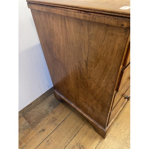 870 - A walnut chest, with a brushing slide, above four graduated drawers, 87 cm wide