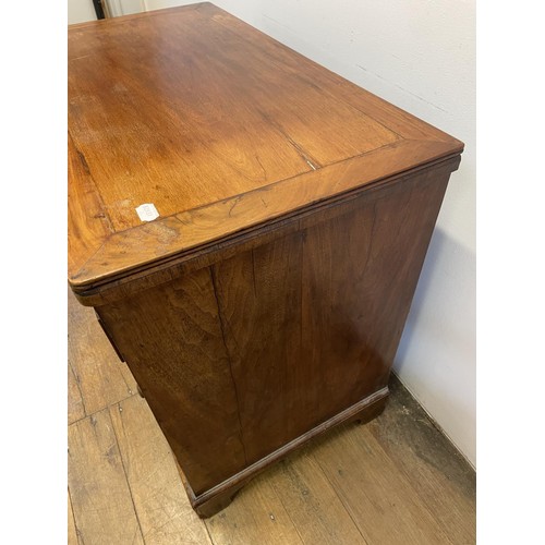 870 - A walnut chest, with a brushing slide, above four graduated drawers, 87 cm wide