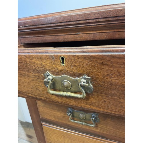 890 - An early 20th century mahogany chest, having a top hat drawer, flanked by four drawers, all above th... 