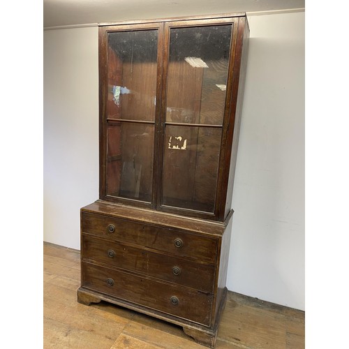 865 - A mahogany bookcase on chest, 220 cm high x 110 cm wide