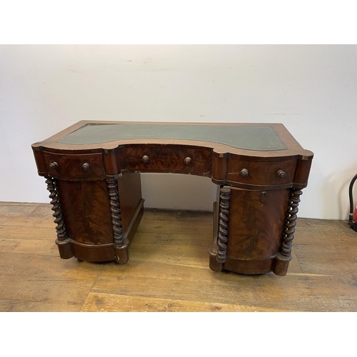 1047 - A mahogany kneehole desk, of shaped outline, having a leatherette inset top, 113 cm wide