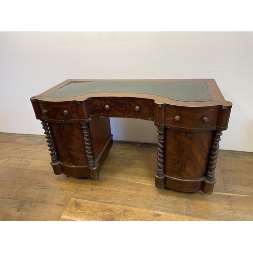 1047 - A mahogany kneehole desk, of shaped outline, having a leatherette inset top, 113 cm wide