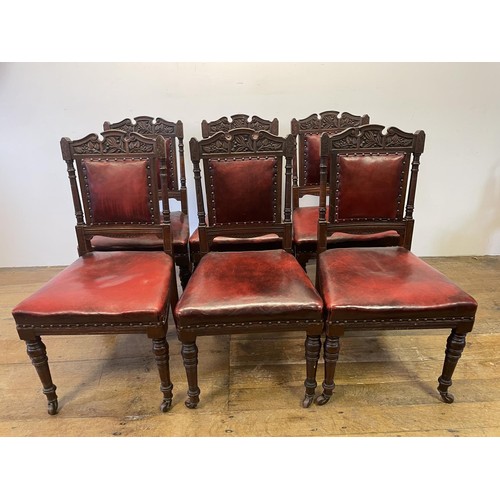 901 - A set of six late 19th century carved walnut dining chairs, with leather padded backs and seats (6)