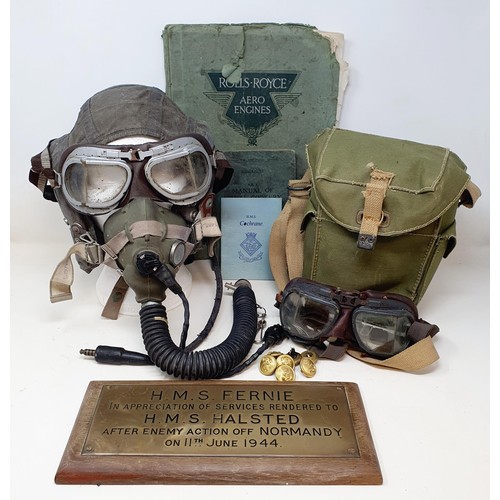 582 - A pilots hat, and attached breathing apparatus, a gas mask, a brass plaque reading HMS Fernie, ... d... 