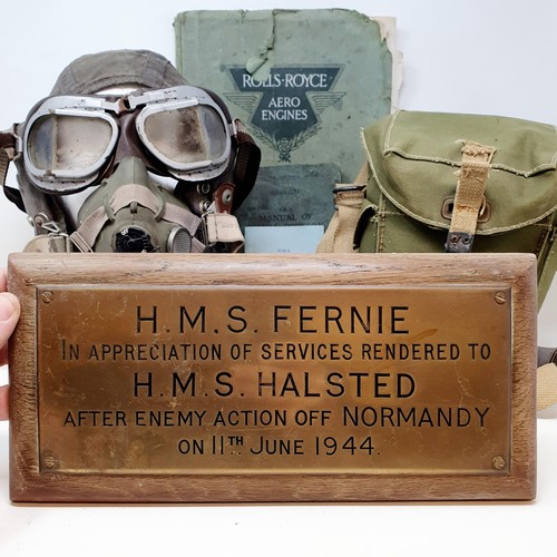 582 - A pilots hat, and attached breathing apparatus, a gas mask, a brass plaque reading HMS Fernie, ... d... 