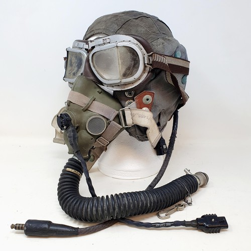 582 - A pilots hat, and attached breathing apparatus, a gas mask, a brass plaque reading HMS Fernie, ... d... 