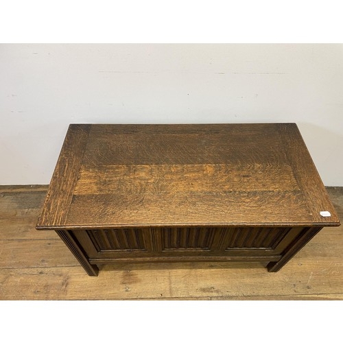 955 - A 17th century style oak coffer, 90 cm wide