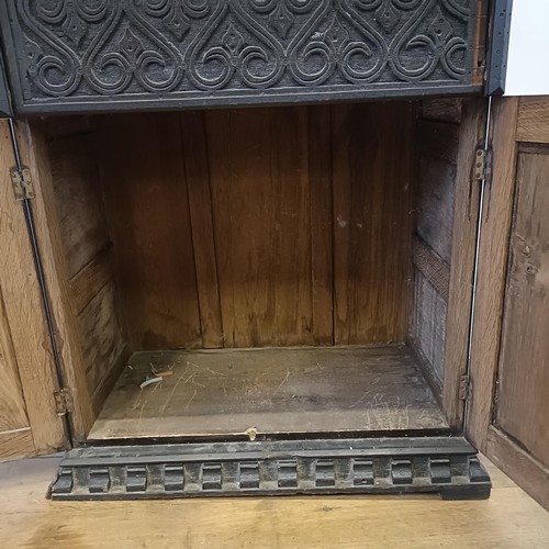 887 - A carved oak cupboard, 62 cm wide